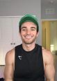 Smiling man in a tank top and green cap, showcasing a healthy lifestyle and positive energy. Perfect for Sambucha promotion.
