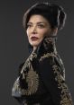 Chrisjen Avasarala, portrayed by Shohreh Aghdashloo, showcases a striking look in elegant black and gold attire.