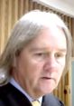 Judge Jeffrey discusses courtroom matters, emphasizing his stance with "I'm Not Packing" in a focused expression.