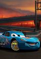 Dinoco Lightning McQueen smiles confidently against a vibrant sunset, showcasing unique wheels and a dynamic racing atmosphere.