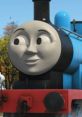 Smiling Edward from Thomas & Friends, showcasing his friendly personality against a vibrant background of trees.