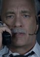 Tom Hanks as Captain Sullenberger in Sully (2016), conveying tension during a critical in-flight emergency call.