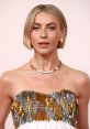 Julianne Hough showcases a stunning sequined dress and elegant jewelry at a glamorous event, highlighting her iconic style.