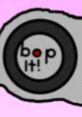 Close-up of the iconic "bop it!" button on a haunted-themed toy, featuring a playful design and vibrant colors.