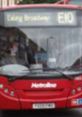 Red bus displaying the route to Ealing Broadway, a popular area for visitors and kebab enthusiasts alike.