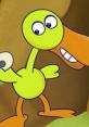 Doris The Duck smiles playfully, showcasing her bright green body and distinctive orange beak in a colorful background.