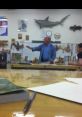 Instructor engaging with students in a workshop, showcasing woodworking skills with tools and materials in the background.
