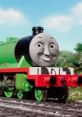 Smiling Henry the Green Engine on the tracks, showcasing his vibrant green color against a scenic background.