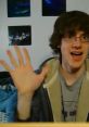 A young person enthusiastically waves, set against a backdrop of ocean-themed artwork, showcasing a lively personality.
