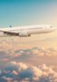 Airplane soaring above fluffy clouds during sunset, showcasing the beauty of air travel and serene aviation experiences.