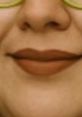 Close-up of a person's lips with a neutral expression, reflecting a generic, boring voice vibe. Subtle makeup detail included.