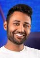 Smiling tech influencer with a stylish haircut, representing Mrwhosetheboss in a vibrant blue background setting.