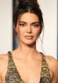 Kendall Jenner showcases stunning makeup and a glamorous gold dress at a recent event, exuding confidence and elegance.