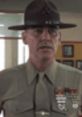 Drill instructor in military uniform, showcasing discipline and leadership in a training environment. Hartmann focus.