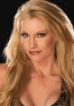 WWE star Sable with long blonde hair and striking makeup, showcasing her captivating smile and confident presence.