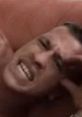 Stressed man expressing discomfort while holding his head, capturing a moment of intense emotion and struggle.