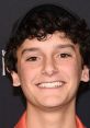 Nicolas Cantu smiles at a celebrity event, showcasing his charm and talent in voice acting, including AI voice projects.