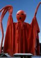 Giant red figure with tentacles and a mask, evoking mystery and intrigue, ideal for Nove-themed art or discussions.