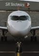 Swiss Bombardier CS100 at SR Technics, showcasing modern aircraft design and advanced aviation technology.