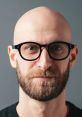 Bald man with a beard and glasses, showcasing a modern look in Michigan. Perfect for style inspiration and personal branding.