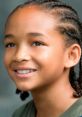 Jaden Smith smiles warmly, showcasing his role in The Karate Kid and capturing the essence of youthful determination.