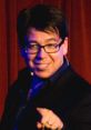 Michael McIntyre performing on stage, engaging the audience with humor and charisma during a live comedy show.