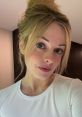 Bri Blossom showcases a fresh and natural look with her stylish bun and soft makeup, radiating confidence and beauty.