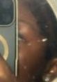 Close-up of a person holding a phone, showcasing focus on personal reflection and modern technology. Malofo vibes captured.