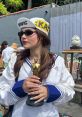 Maddie Jackson poses with an Oscar statuette, sporting a trendy outfit and sunglasses, exuding confidence and style.