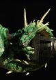 Detailed green dragon figurine with sharp claws and piercing orange eyes, showcasing intricate scales and fierce expression.