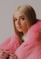 Poppy ASMR featuring a chic look with pink faux fur, exuding a soft and glamorous vibe. Perfect for style inspiration.