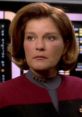 Captain Kathryn Janeway from Star Trek: Voyager in her iconic uniform, reflecting a moment of leadership and determination.