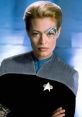 Seven of Nine from Star Trek: Voyager, wearing a Starfleet uniform, with distinctive Borg facial implants.