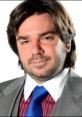 Matt Berry as Douglas Reynholm, exuding confidence in a stylish suit with a blue tie, known for his role in "The IT Crowd.