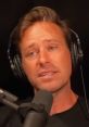 Armie Hammer discussing personal insights during an interview, wearing headphones and speaking into a microphone.