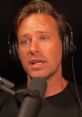 Armie Hammer discussing personal experiences in an interview setting, wearing headphones and speaking into a microphone.
