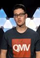 James from QualityMobileVideo presenting with a stylish QMV shirt against a modern background. Engaging tech-focused content.