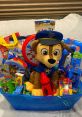 Colorful gift basket filled with toys, including a plush police dog, art supplies, and educational items for kids.