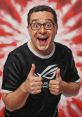 RicFazeres celebrates gaming with a big smile and thumbs up, showcasing enthusiasm for gaming culture and community.