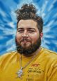 Stylish young man with beard and top knot, wearing a yellow Off-White tee and silver skull pendant against a blue backdrop.