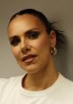 Stylish portrait of Esther S, showcasing elegant earrings and makeup, exuding confidence and sophistication.