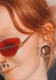 Individual with vibrant red hair wearing stylish red sunglasses and ear gauges, showcasing unique facial tattoos.