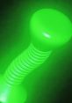 Glow-in-the-dark green toy resembling a dumbbell, ideal for interactive games like "Flick It" and playful activities.