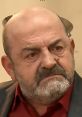 Gazmend Berisha expressing intense emotion with a serious expression, highlighting his role as E Drejtori.