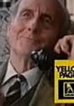 J R Hartley talking on the phone while looking cheerful and nostalgic, connected to his search for a fly fishing book.