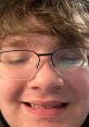 Close-up portrait of a young man smiling, showcasing a light-hearted vibe reminiscent of the "Flowerpot (SNICK BOY)" aesthetic.