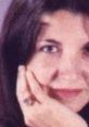 Close-up of a thoughtful woman resting her chin on her hand, featuring dark hair and a serene expression.