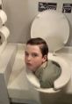 Boy humorously stuck in a toilet, showcasing a funny and unexpected scenario reminiscent of "Lukie Pookie" antics.
