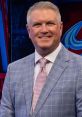 Marc Moser, Colorado Avalanche broadcaster, smiling in a stylish light blue suit and pink tie, ready for a game.