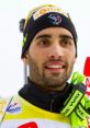 Martin Fourcade smiles after a competition, showcasing his athletic gear and commitment to biathlon excellence.